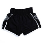 Fighter wearing MTM Essentials Muay Thai Shorts in black, side view