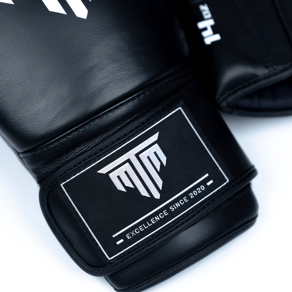 Close-up of MTM Sport Pro X1 Velcro Boxing Gloves in black, showing texture