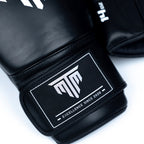 Close-up of MTM Sport Pro X1 Velcro Boxing Gloves in black, showing texture