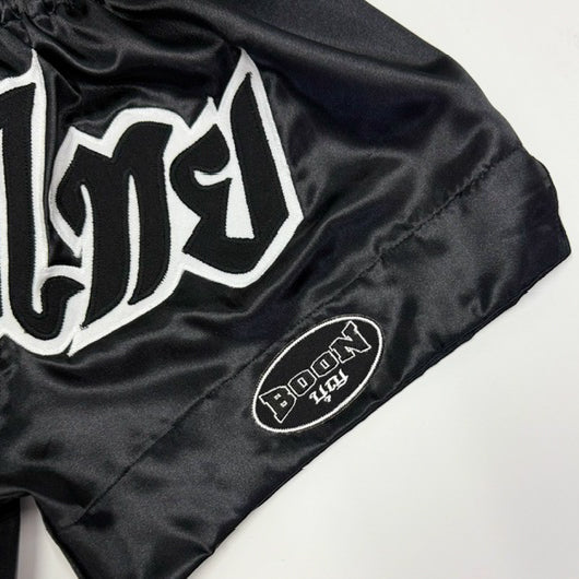 Close-up of the 'Muay Thai' lettering on BOON Sport Classic Shorts