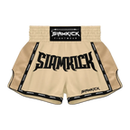 Siamkick Fightwear Muay Thai shorts in beige with black trim, featuring a large black 'SIAMKICK' logo on the front and a black waistband label.