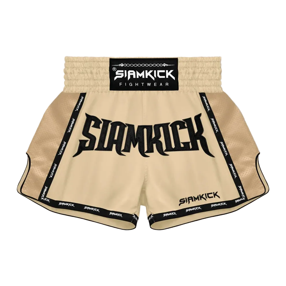 Siamkick Fightwear Muay Thai shorts in beige with black trim, featuring a large black 'SIAMKICK' logo on the front and a black waistband label.