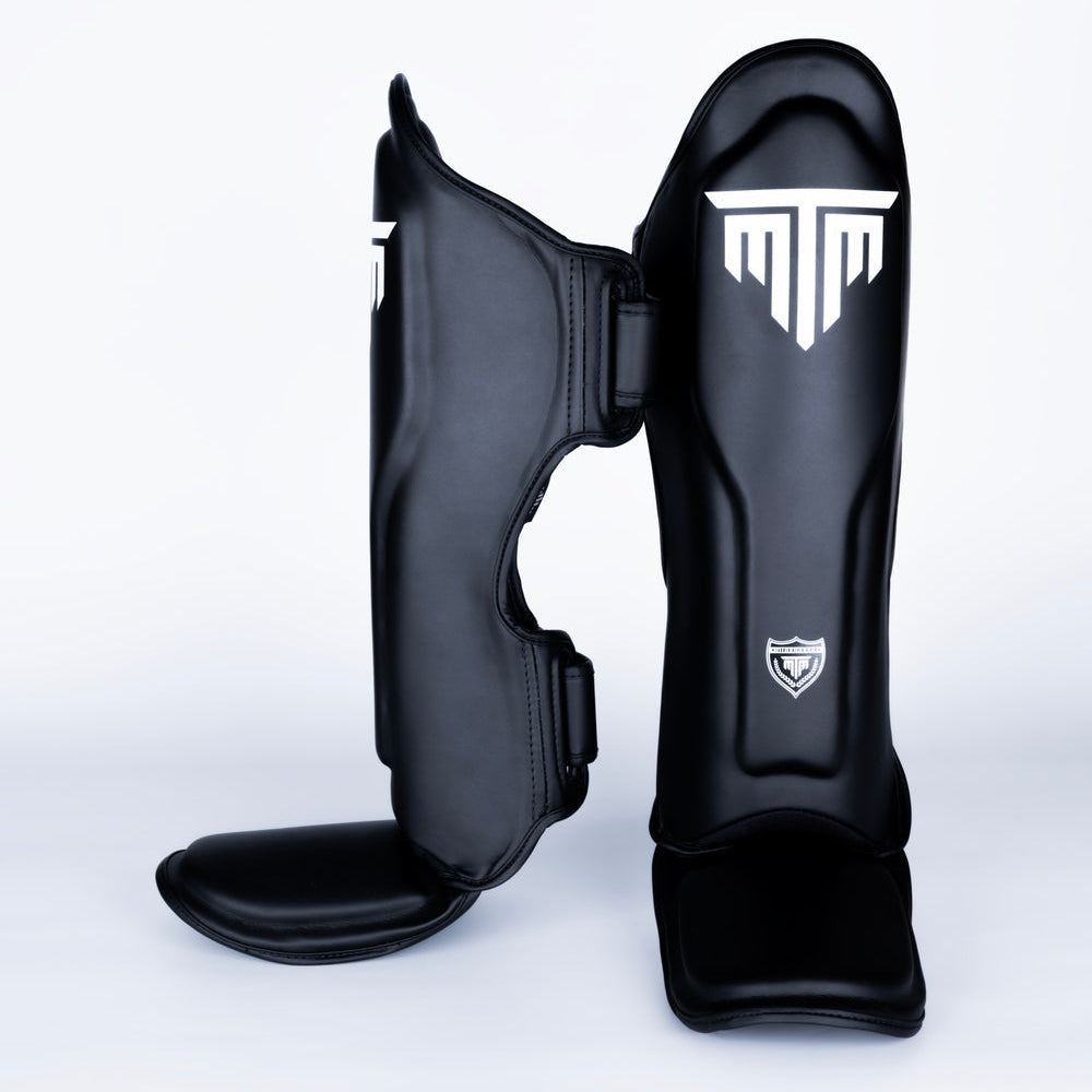 MTM Sport VX Shin Guards in black, front view on white background