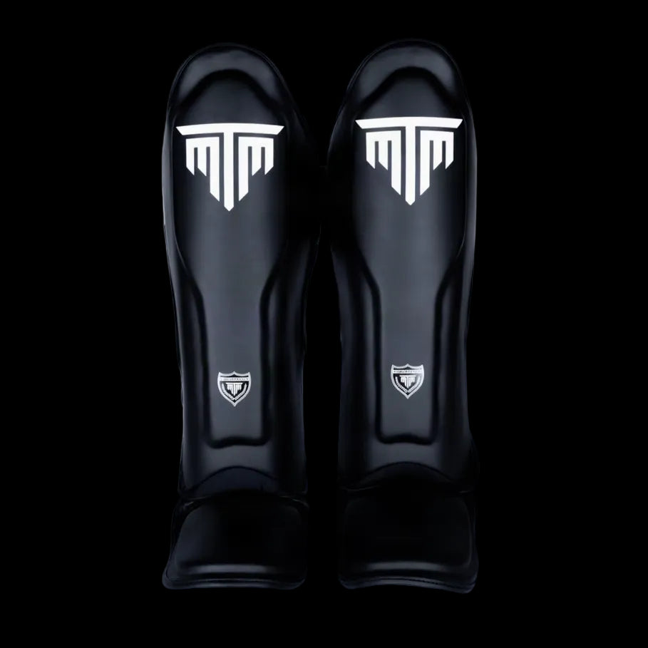 MTM Sport VX Shin Guards in black, side view on white background